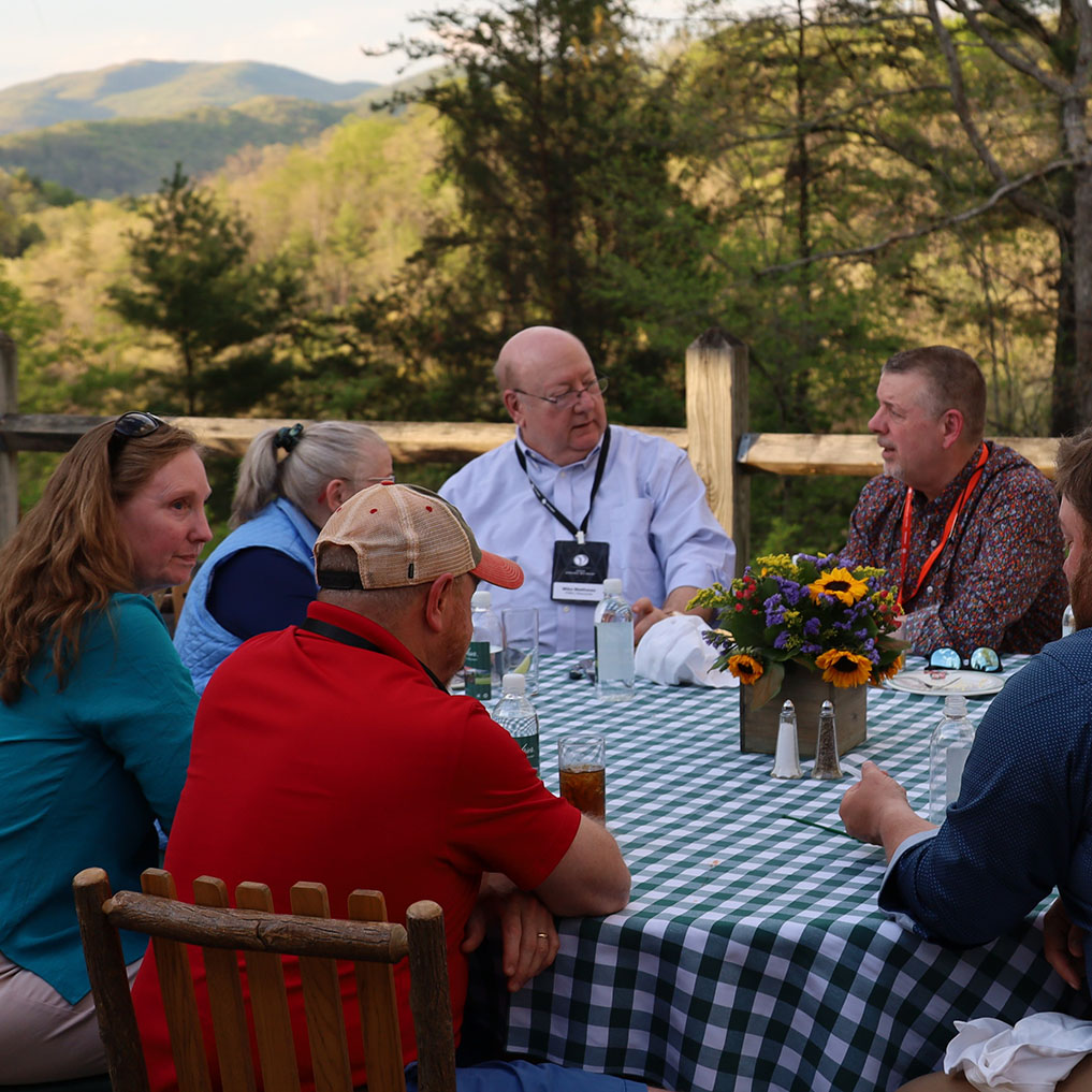 group gathered around table at VACEOs retreat