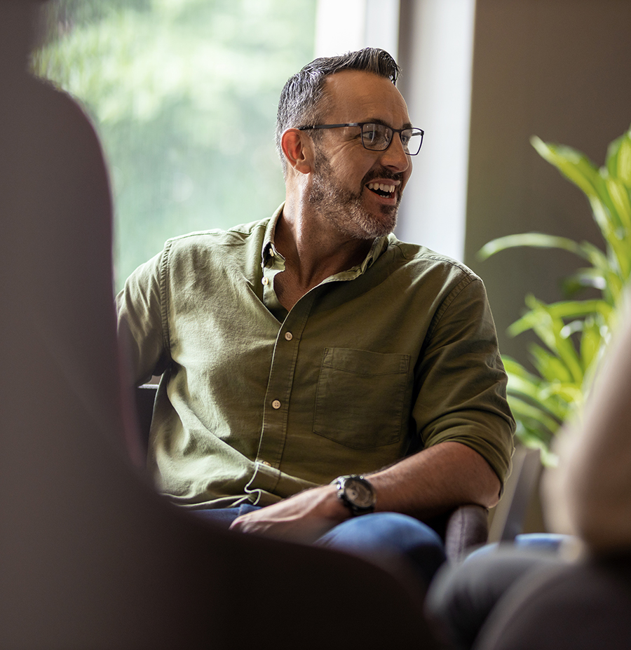 Man sitting with others