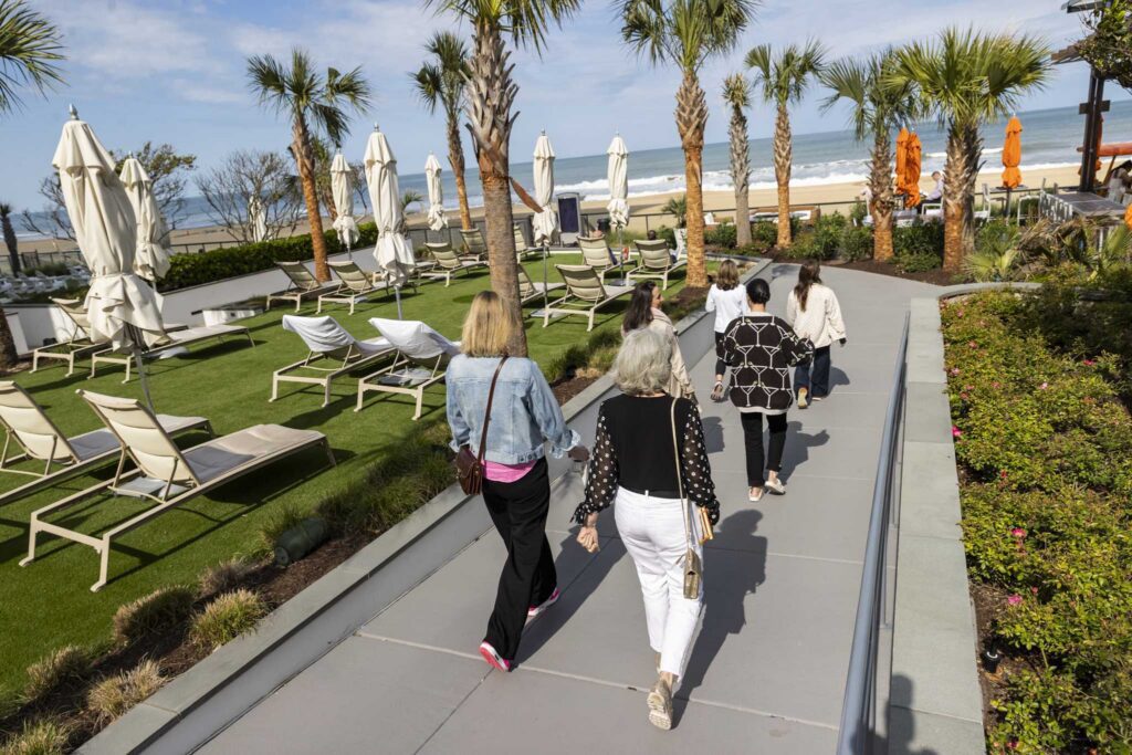 Women CEOs walking to the beach during VACEOs Spring Retreat 2026